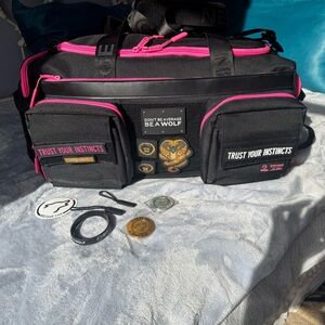 Black and Pink Travel Bag. 40 L Wolfpak Has a few flaws but all hardware works
